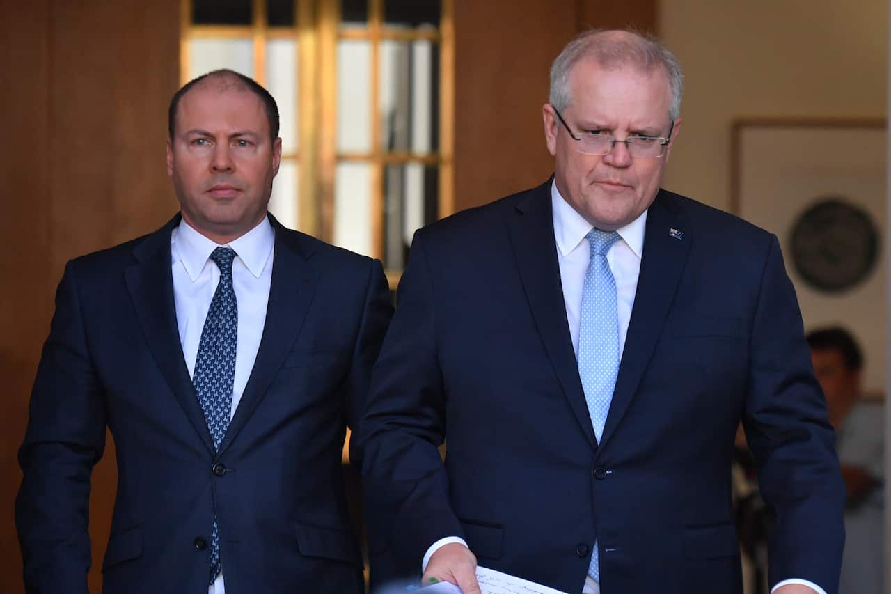 Treasurer Josh Frydenberg and Prime Minister Scott Morrison arrive at a press conference to announce the government's coronavirus stimulus package at Parliament House in Canberra, Sunday, March 22, 2020. (AAP Image/Mick Tsikas) NO ARCHIVING