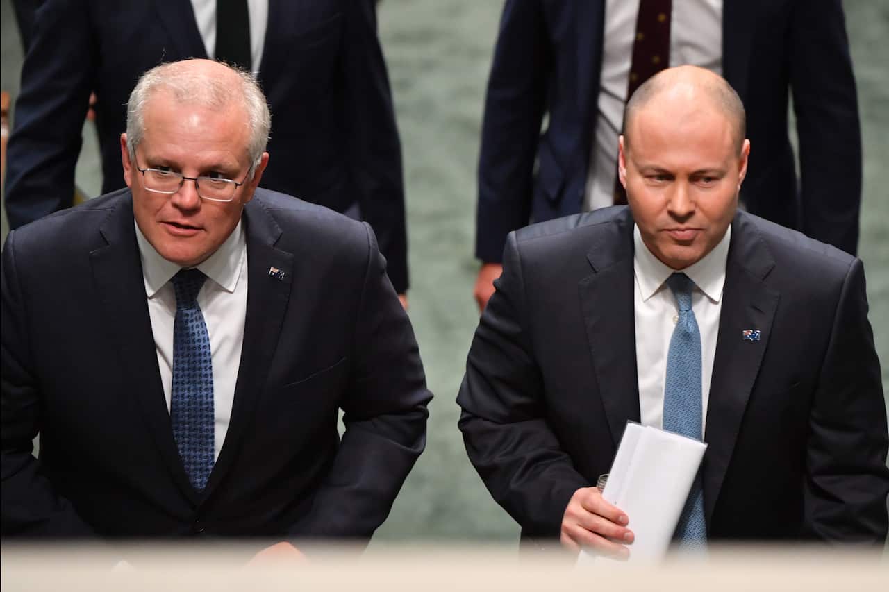 Prime Minister Scott Morrison and Treasurer Josh Frydenberg leave after handing down their second Federal Budget in the House of Representatives
