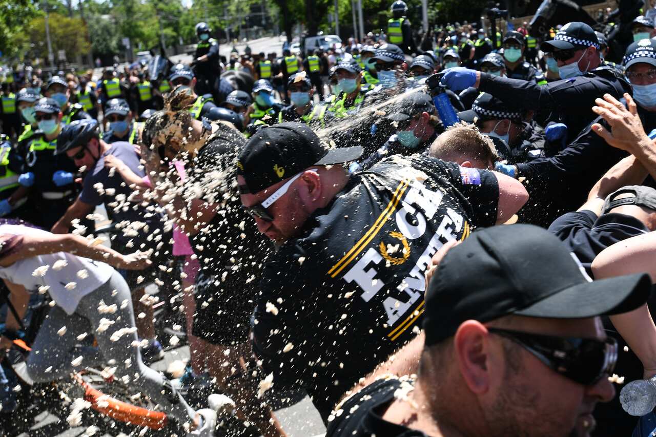 Police use OC spray on protesters during an anti-lockdown protest in Melbourne.