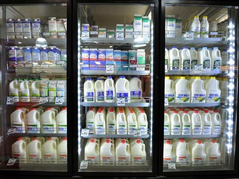 Milk on sale inside a Woolworths grocery store.