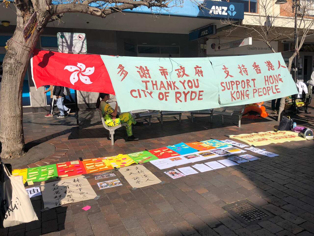 People demonstrating along Lennon Street in Eastwood supporting Hong Kong protests.