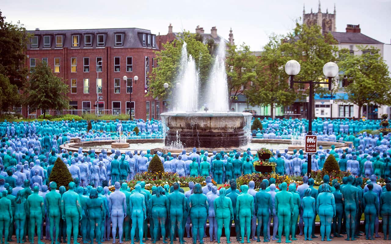 People stand in a public park taking part in a mass nude art installation entitled Sea of Hull by New York based artist Spencer Tunick in Hull, England in 2016.