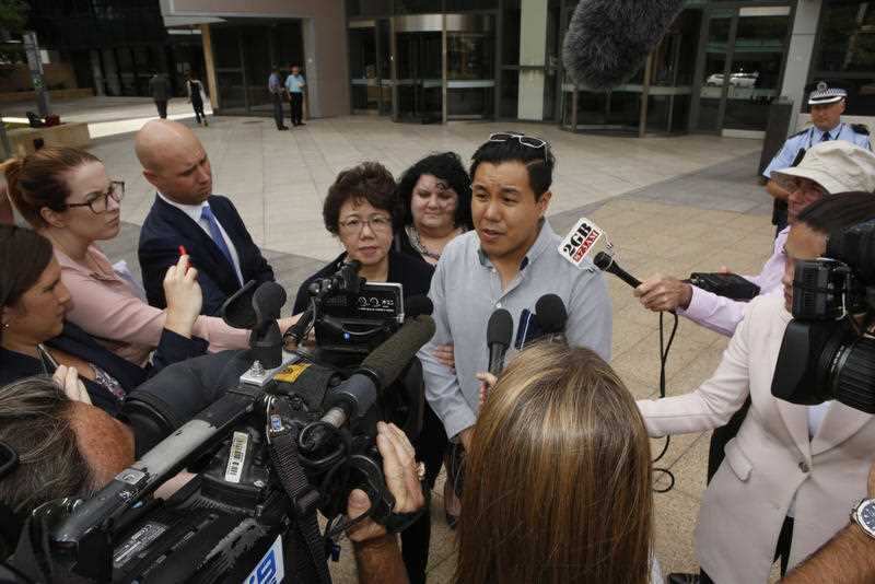 Curtis Cheng's son Alpha Cheng (center right) and widow Selina Cheng (centre left) speak to the media outside Parramatta District Court in Sydney.