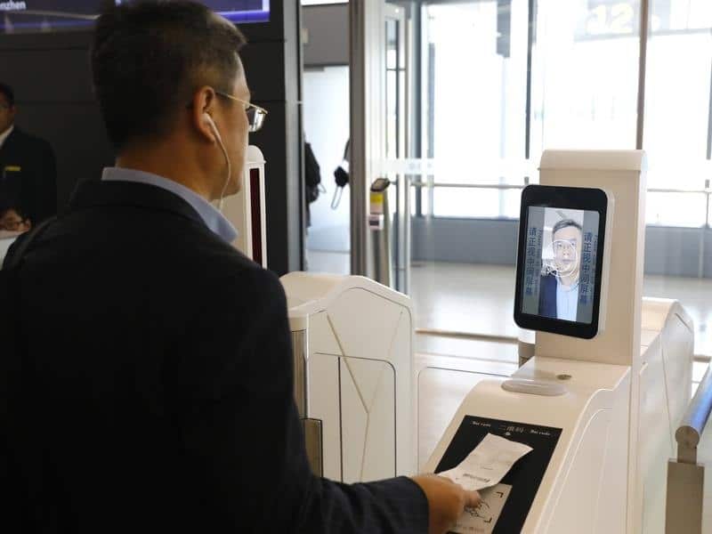 A man at a facial recognition machine at Shanghai airport.
