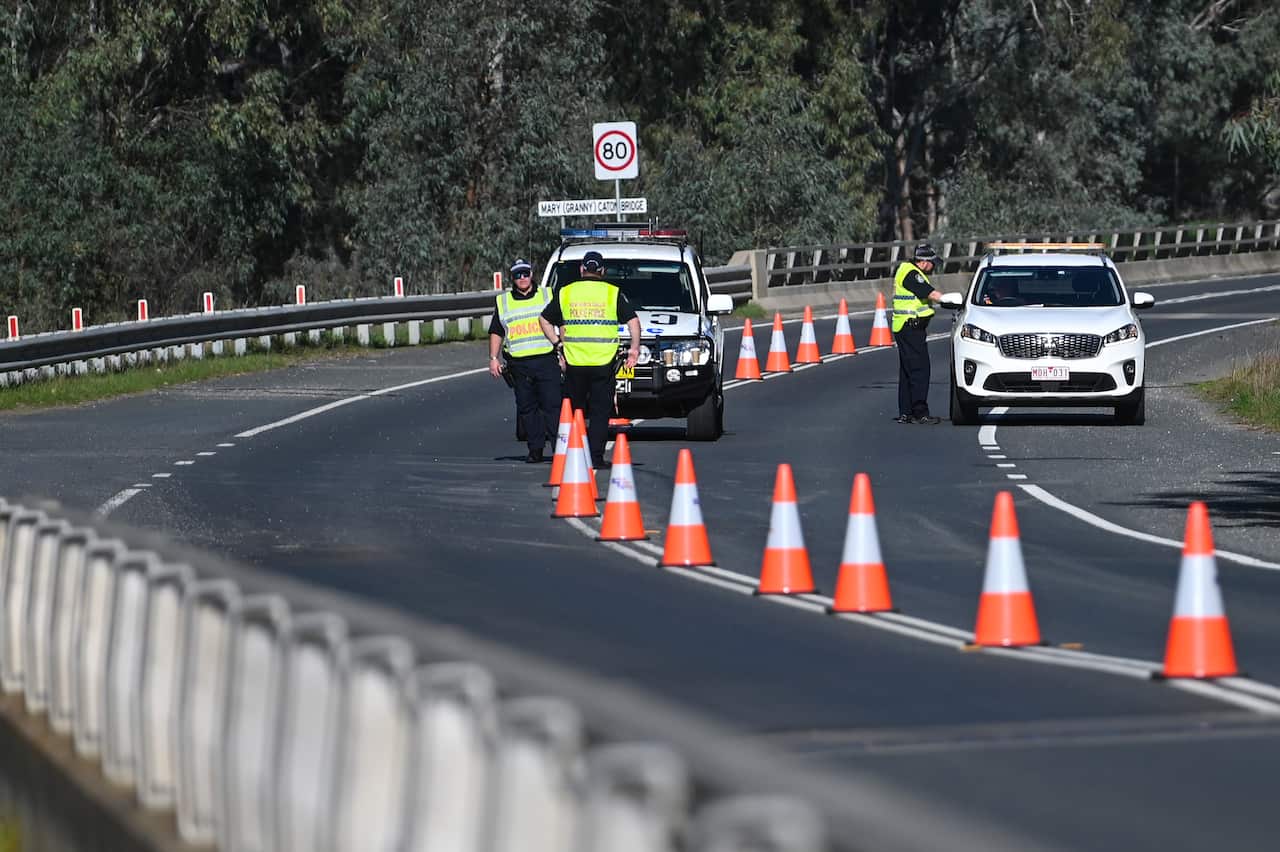 NSW Police officers are seen at the NSW-Victoria border crossing in Howlong near Albury, NSW, on 8 July, 2020. 