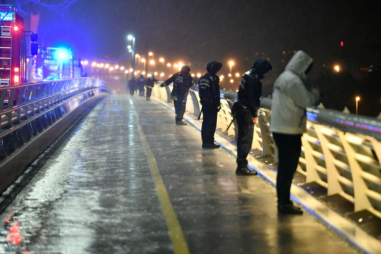 Rescuers and police officers inspect the River Danube.
