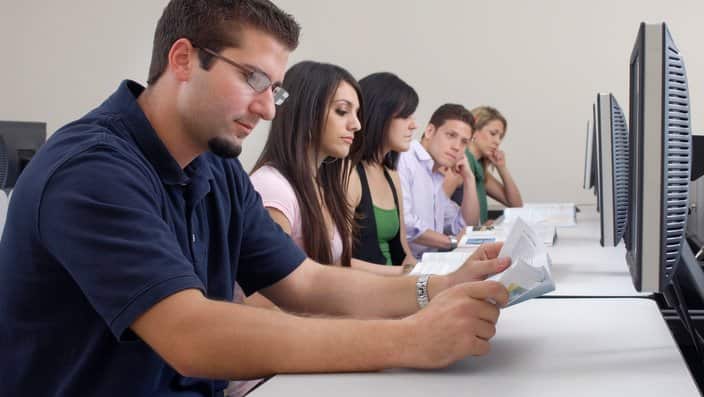 Five students working in computer classroom