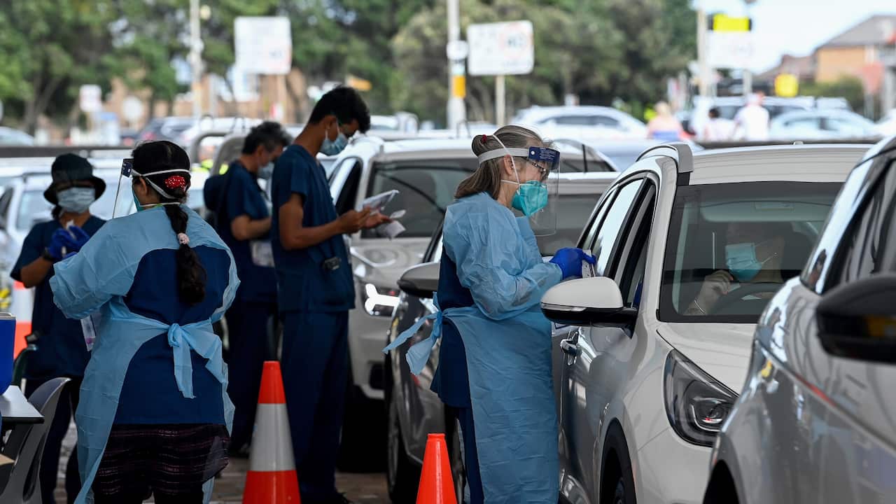Health care workers administer COVID-19 PCR tests at the St Vincents Drive-through Clinic at Bondi Beach in Sydney