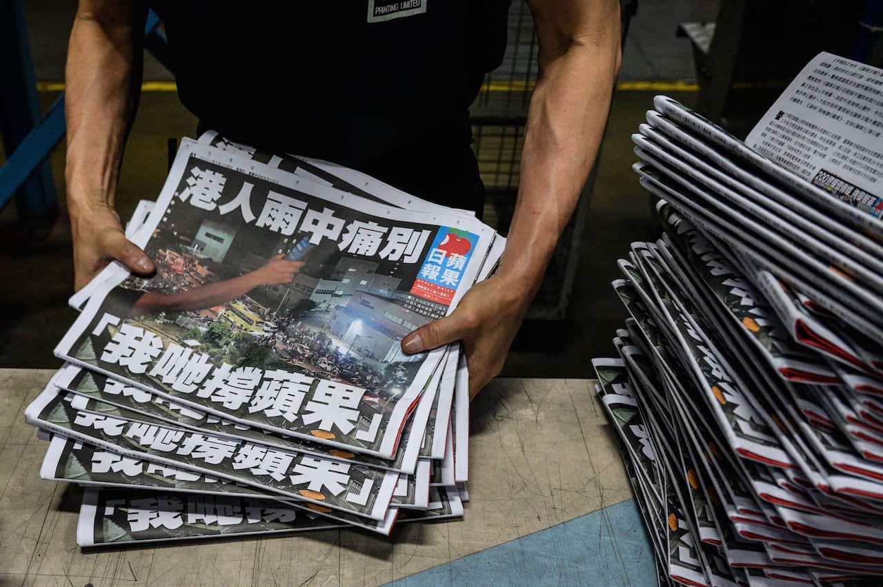 An Apple Daily employee works in the printing room after the last edition of the newspaper is printed in Hong Kong early on 24 June, 2021.