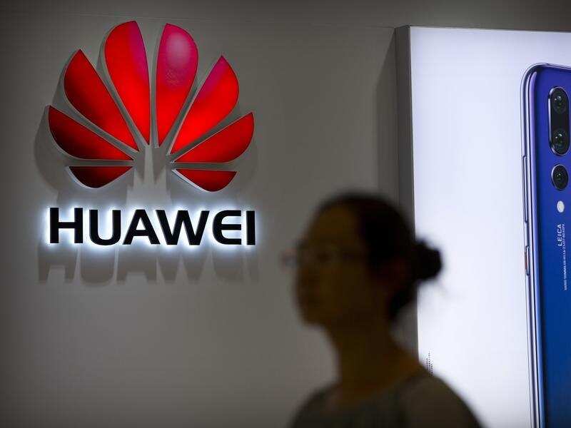 A shopper walks past a Huawei store.
