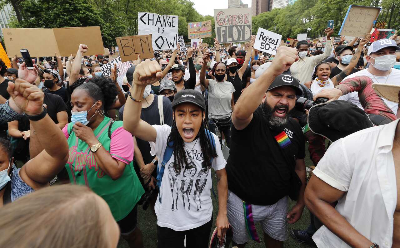 Protesters rally during a George Floyd Memorial demonstration  in Brooklyn , New York.