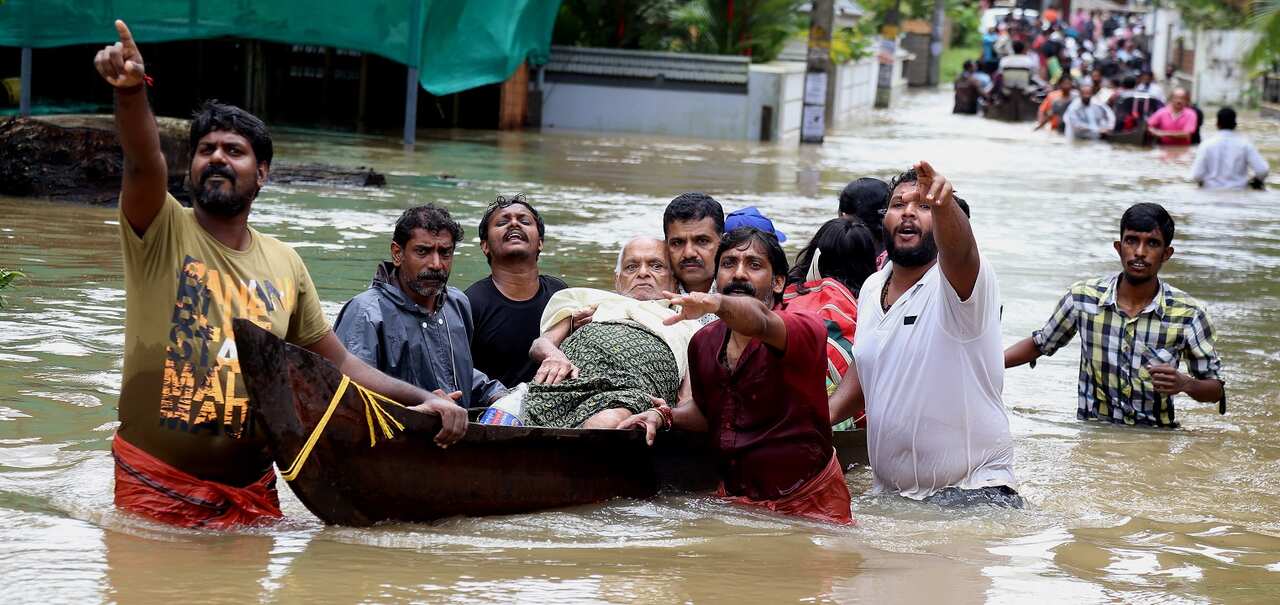 An elderly man is rescued from flood waters in Kochi, Kerala state