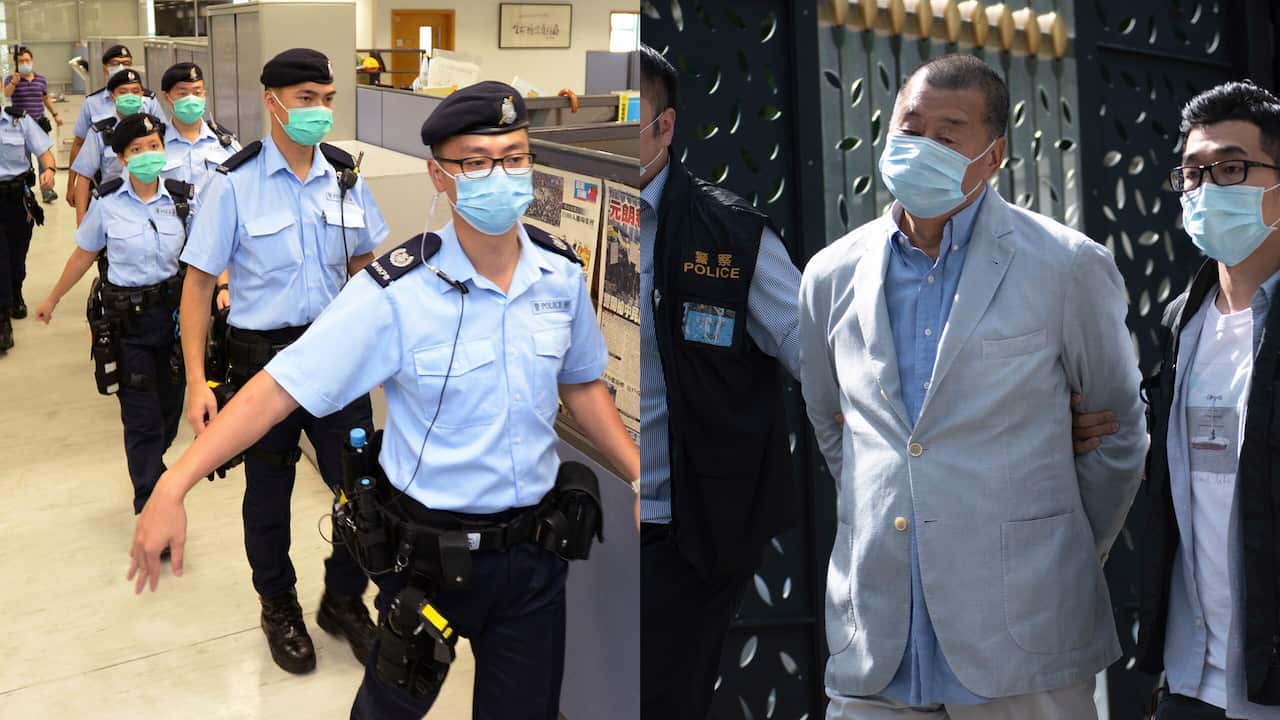 Police officers take action inside Apple Daily headquarters as Hong Kong media tycoon and founder Jimmy Lai is arrested.