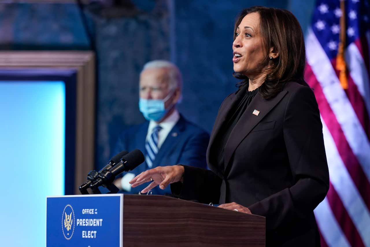 President-elect Joe Biden listens as Vice President-elect Kamala Harris speaks.