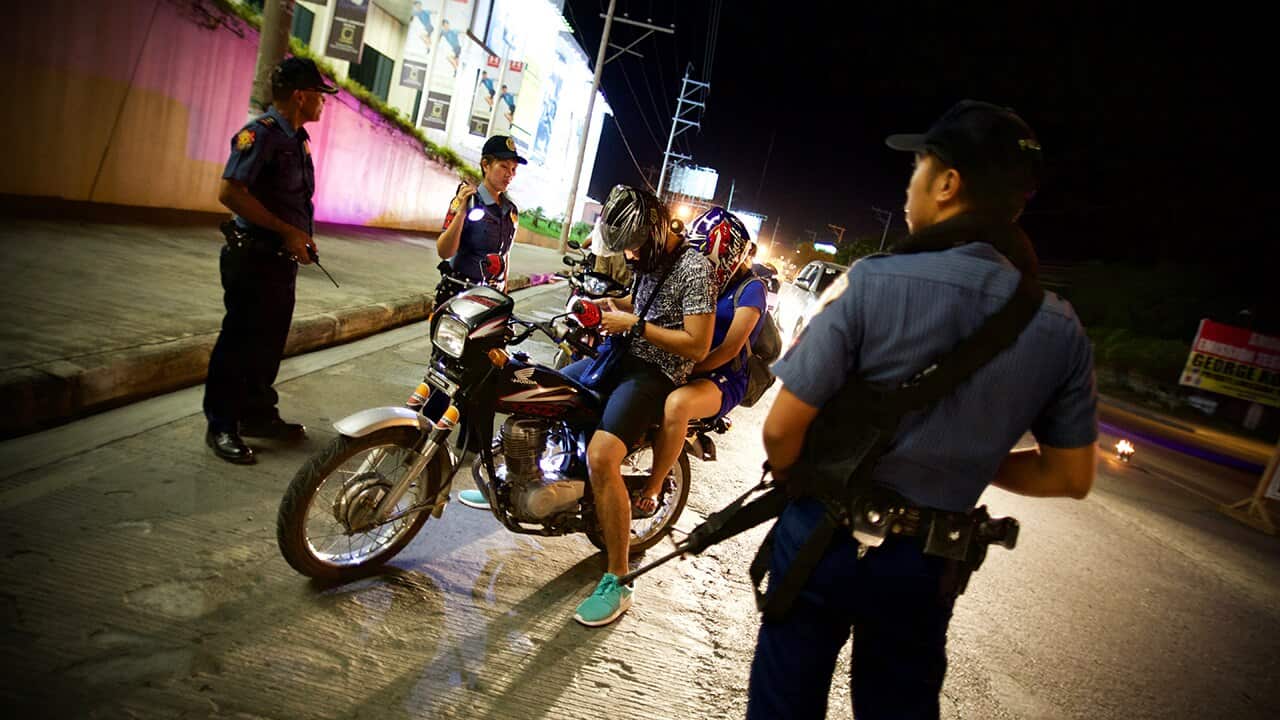 Heavily armed police carry out a routine ID check in Davao. As mayor, Duterte's zero tolerance approach to crime and drugs is credited for cleaning up the city.
