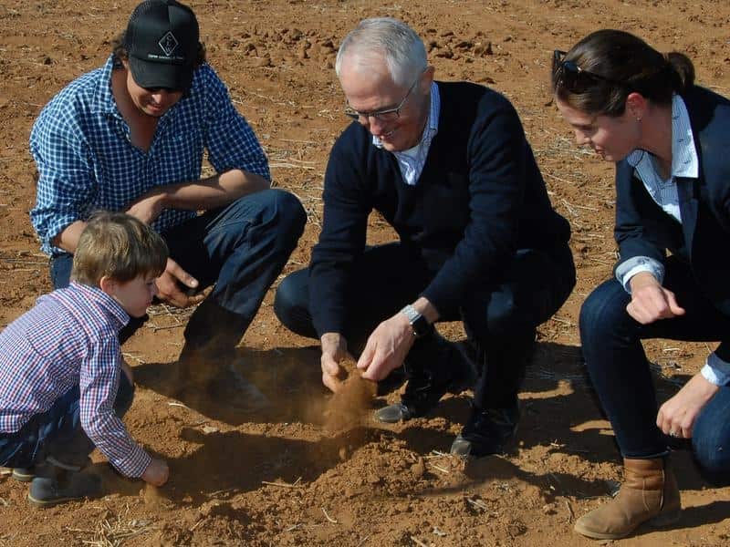 Prime Minister Malcolm Turnbull speaks with a farmer and his family