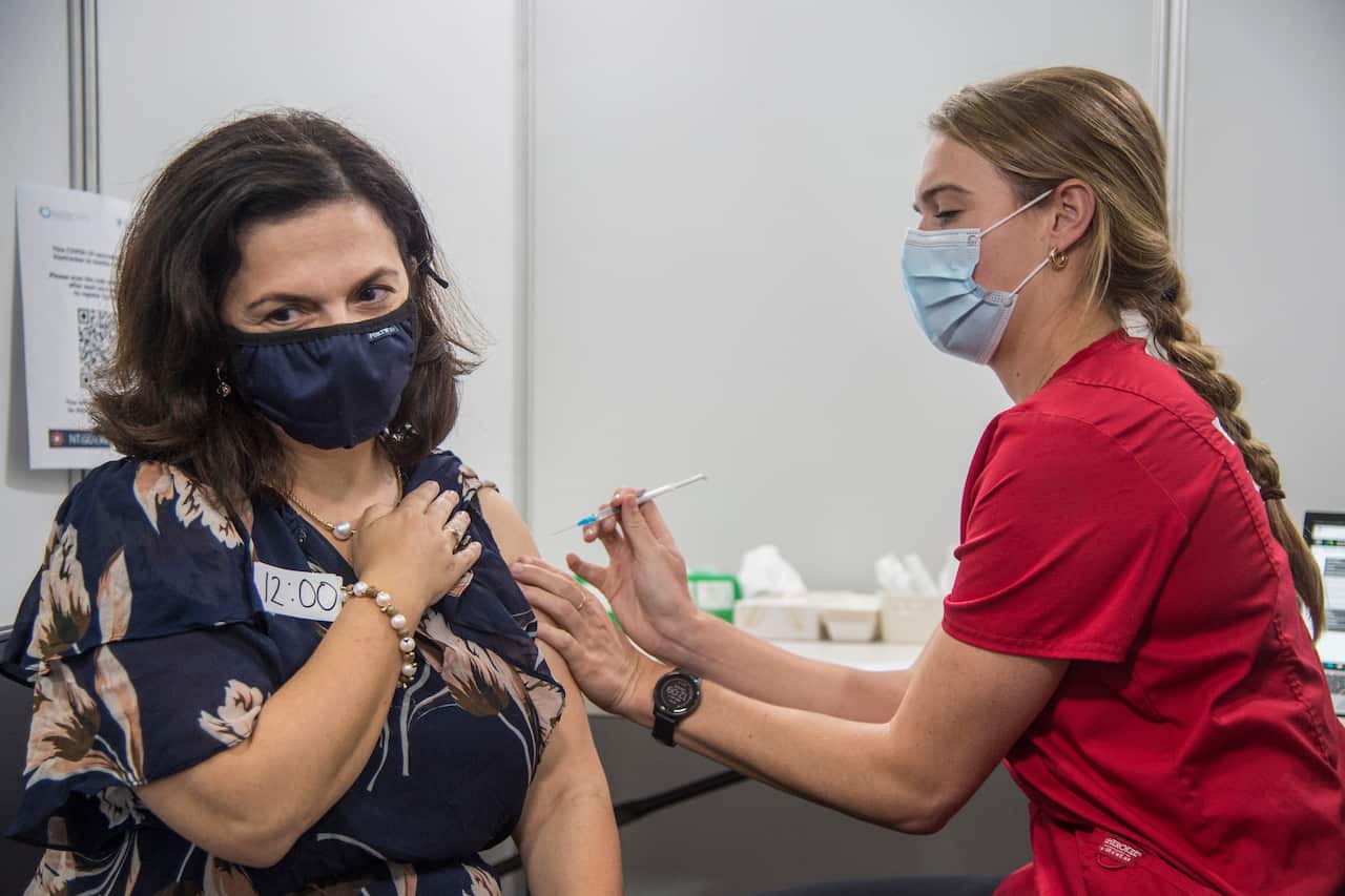A Northern Territory health worker gives an eligible Territorian their first does of the Pfizer COVID-19 vaccine at the new Darwin COVID-19 Vaccination Centre in Marrara, Darwin, Wednesday, July 7, 2021. (AAP Image/Aaron Bunch) NO ARCHIVING