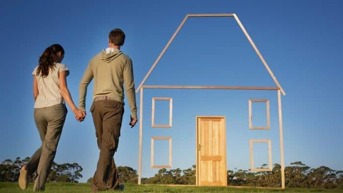 Couple walking towards vertical house outline
