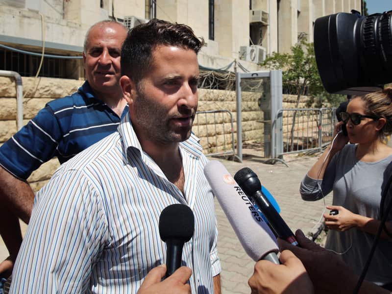 Lebanese father Ali al-Amin speaks to journalists