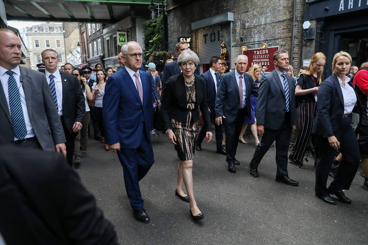 Britain's Prime Minister Theresa May and Prime Minister Malcolm Turnbull walk through Borough market in London, Britain.