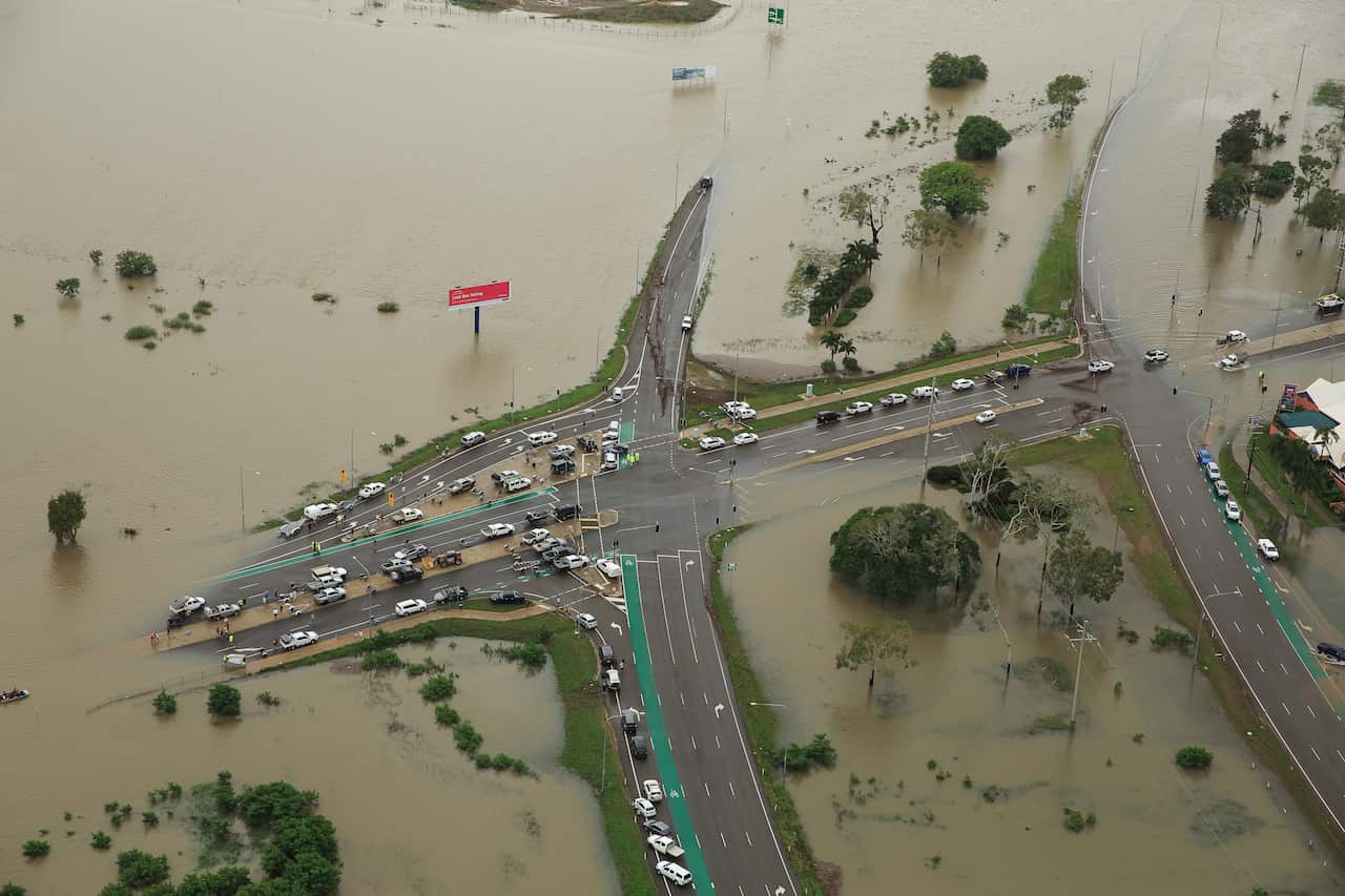 Stranded vehicles are seen from above as floodwater engulfs the intersection of Stuart Drive and the Bruce Highway in Townsville, Monday, 4 February, 2019.