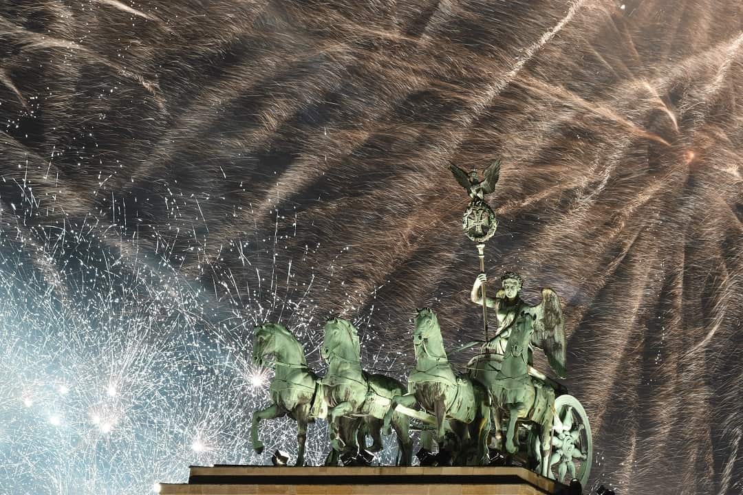 Fireworks illuminate the sky over the Quadriga statue of Germany's Brandenburg Gate.