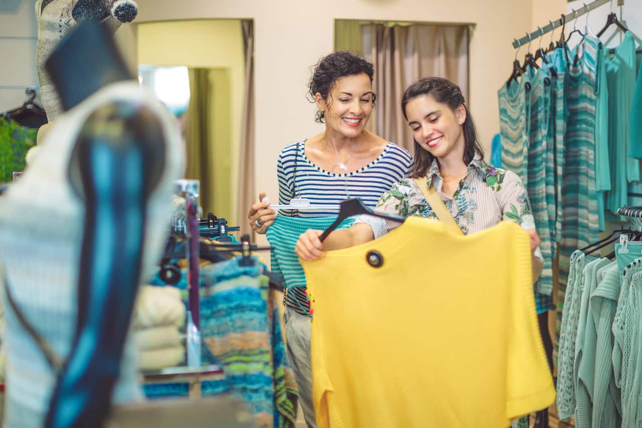 Mother and her adult daughter are buying clothes 