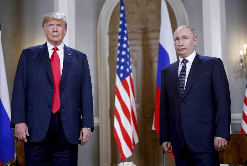 U.S. President Donald Trump, left and Russian President Vladimir Putin, right, stand together before the start of their meeting at the Presidential Palace in Helsinki, Finland, Monday, July 16, 2018.