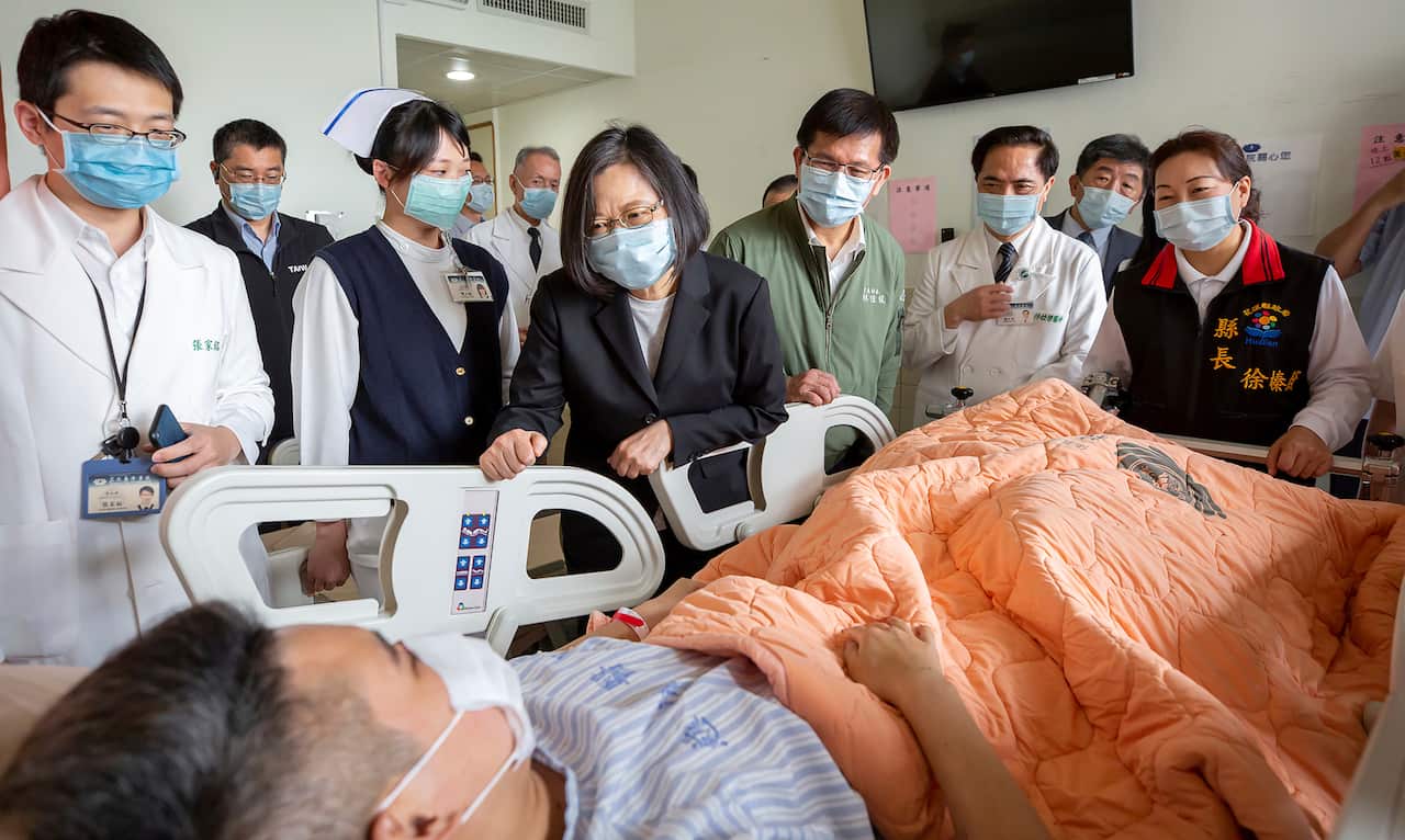 Taiwan President Tsai Ing-wen (C) visits those injured in a train derailment at a near by hospital in Hualien, eastern Taiwan.