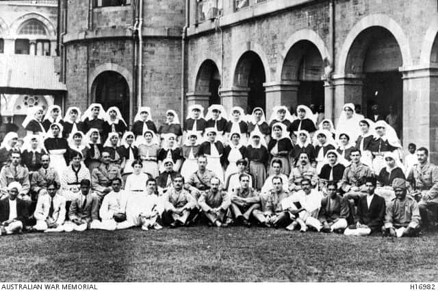 Bombay, India. 1918. Group photograph of Nursing Sisters, Doctors, Chemists, and Native Orderlies at the Freeman Thomas Hospital. 