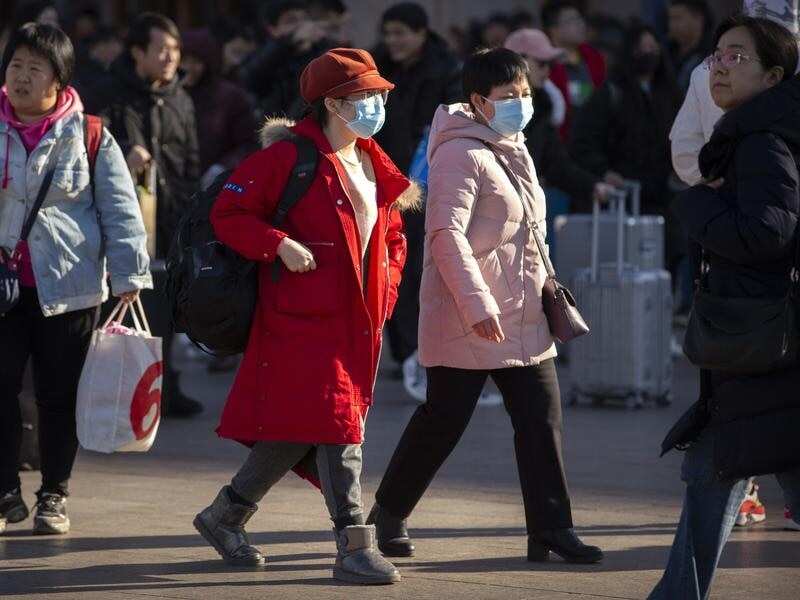 Travelers wear face masks.