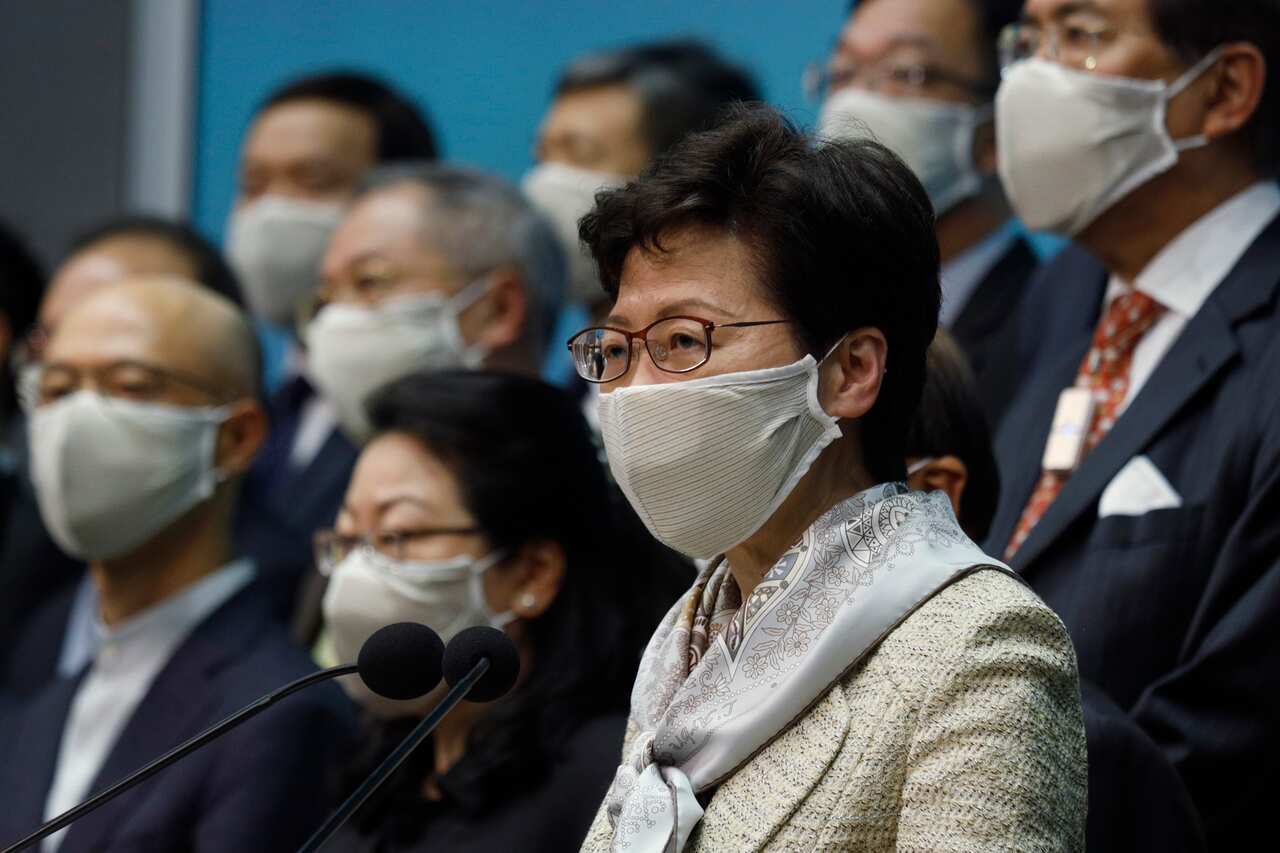 Hong Kong Chief Executive Carrie Lam, center, and other officials attend a press conference in Hong Kong after returning from China's NPC meeting.