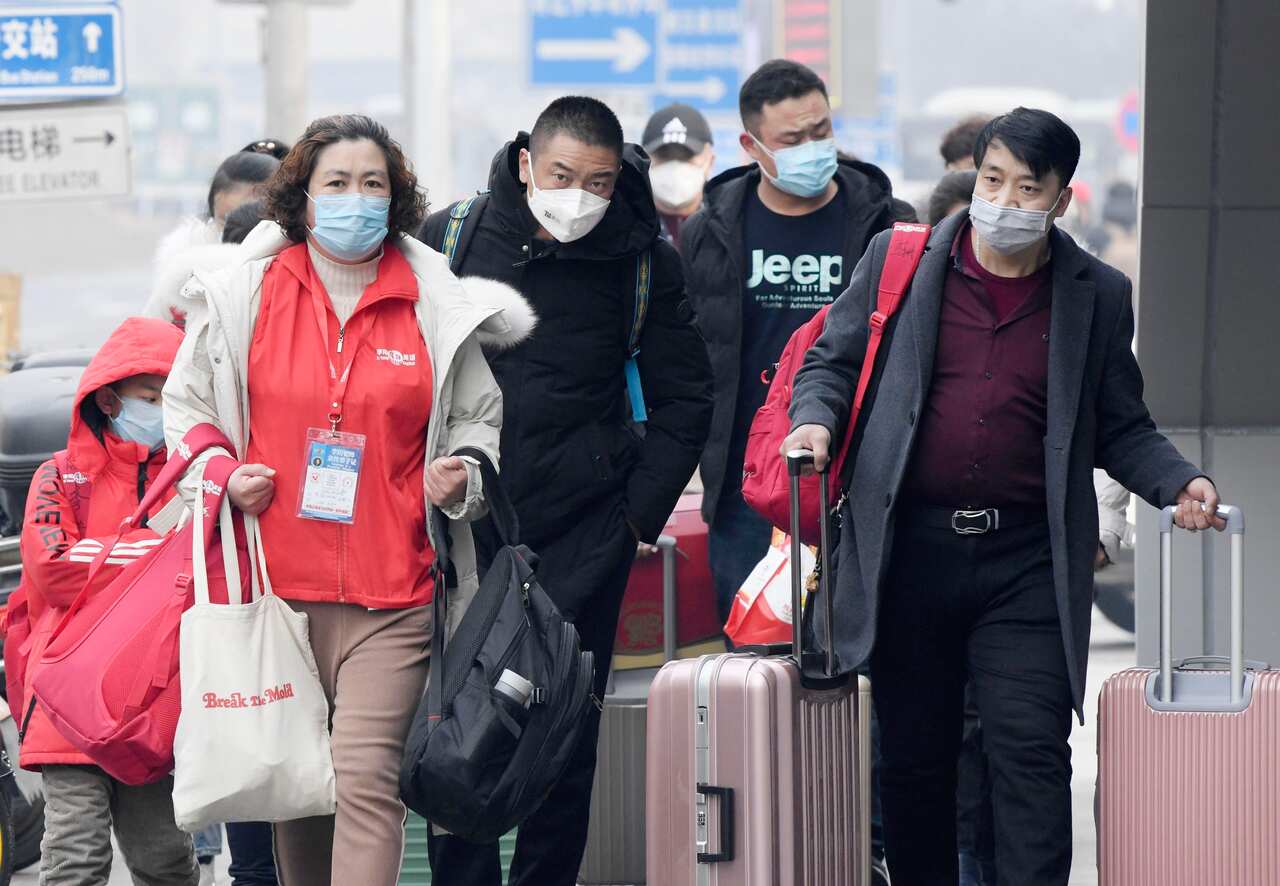 People wear masks in Beijing on Jan. 26, 2020, amid the spread of pneumonia caused by a new coronavirus in the central Chinese city of Wuhan. (Kyodo via AP Images) ==Kyodo