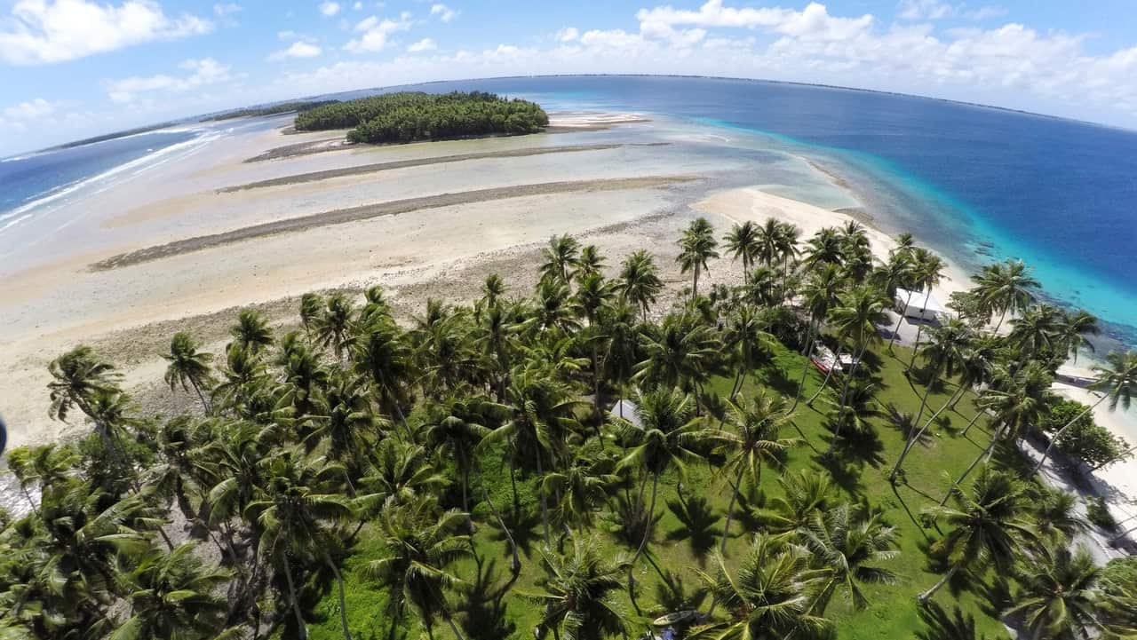 This 2015 photo shows a large section of land washed away due to continuing rising sea leaves on Majuro Atoll, Marshall Islands.  