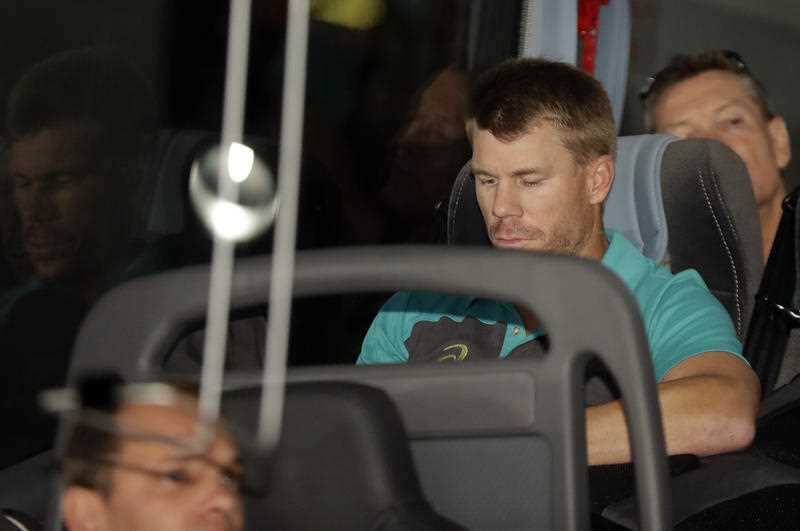 Australia's David Warner, is seated on the team bus after the arrival of the Australian team to OR Tambo International International airport in Johannesburg, South Africa, Tuesday, March 27, 2018.