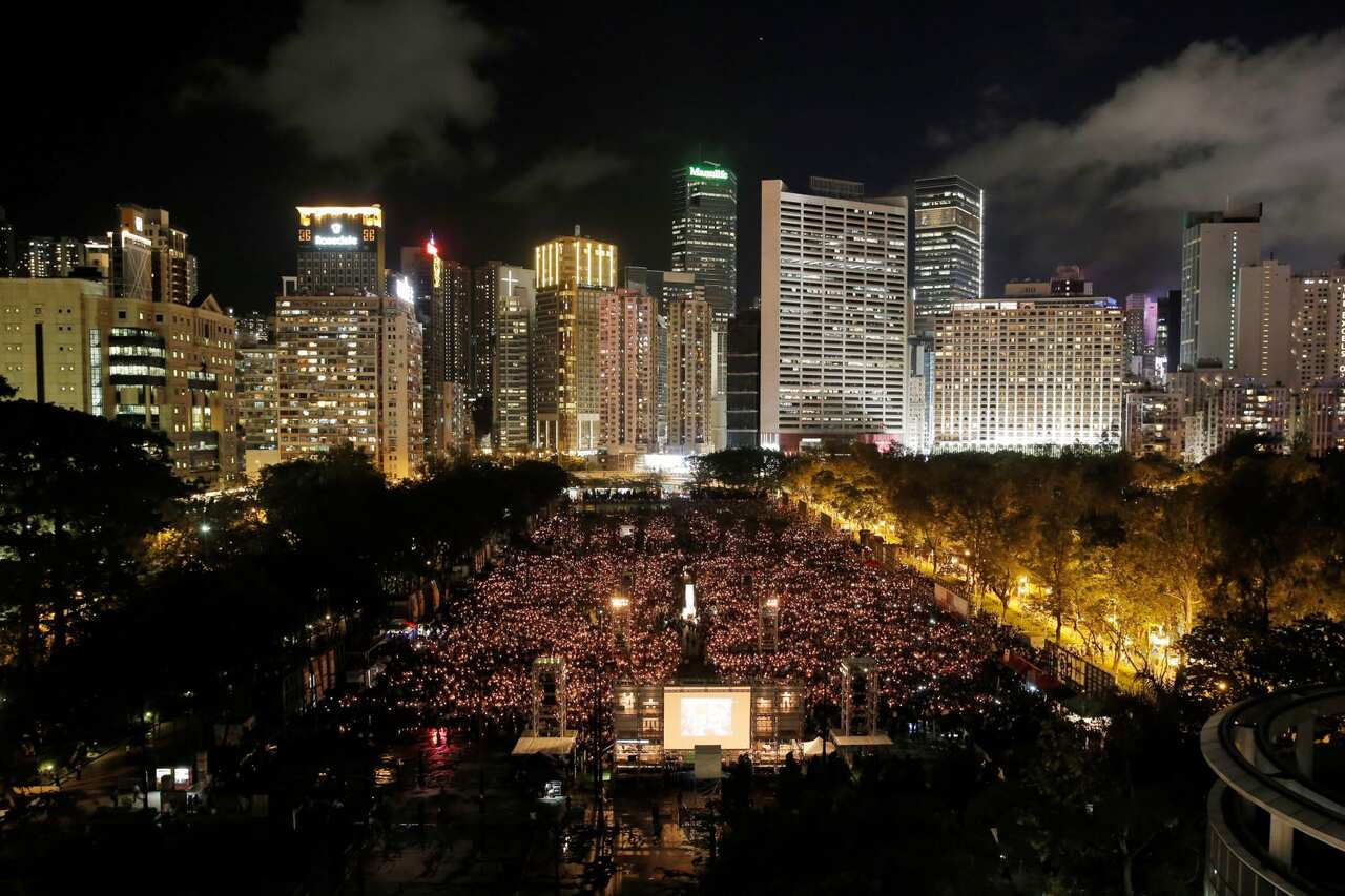 Tens of thousands of people attend an annual candlelight vigil at Hong Kong's Victoria Park, Monday, June 4, 2018. 