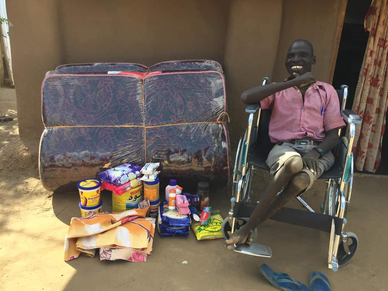 Machar is setting outside his house in kakuma 