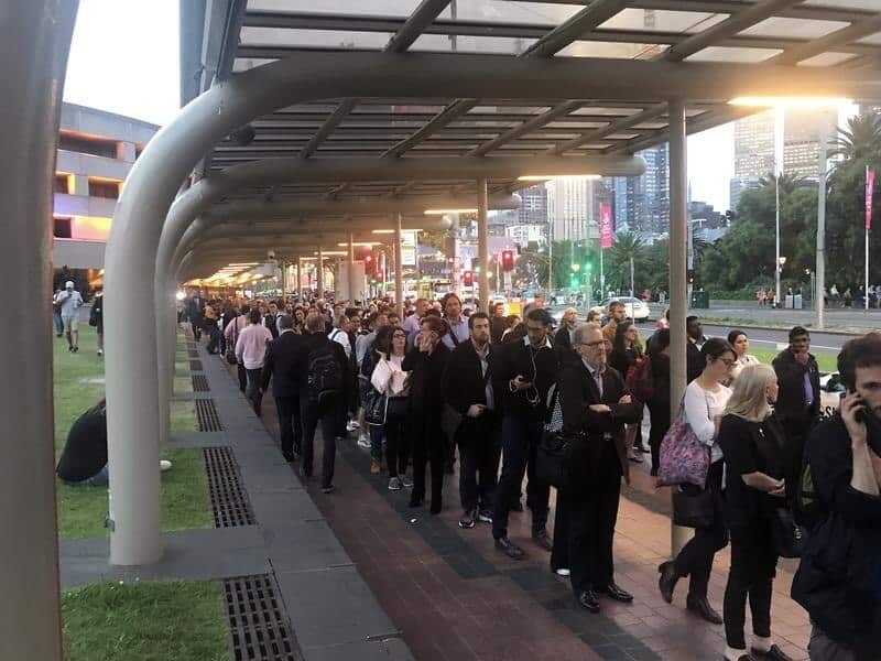 Commuters are seen queuing during train delays in Melbourne,