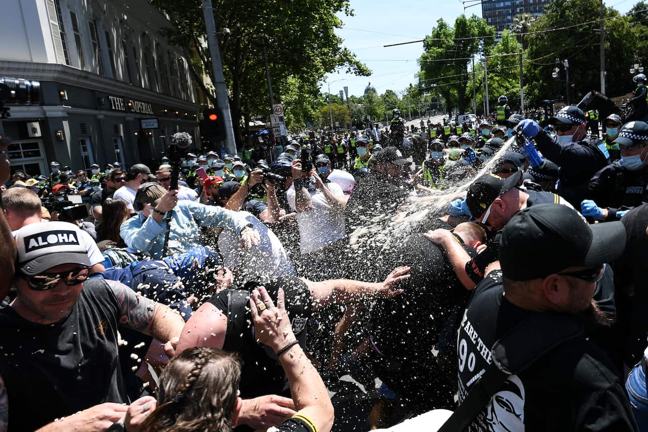 Police use OC spray on protesters during an anti-lockdown protest in Melbourne.