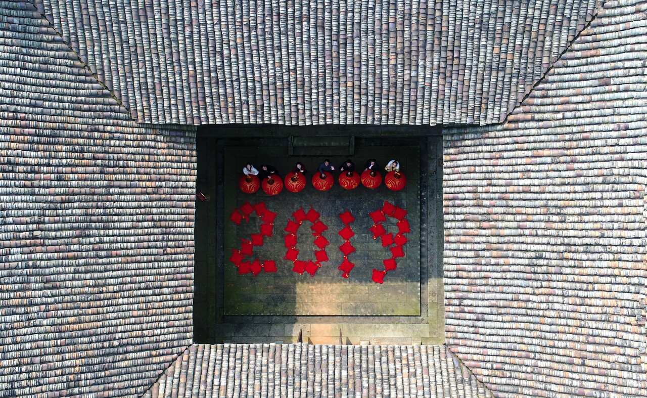 Aerial view of villagers holding red lanterns as they prepare to usher in the 2019 Chinese New Year, the Year of the Pig.