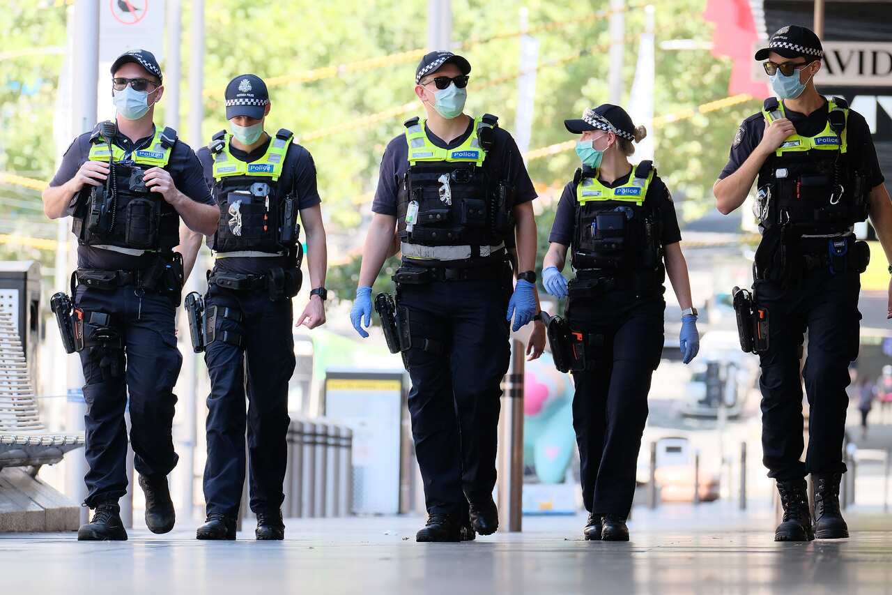 Victorian Police officers walk around  Melbourne’s CBD , Monday, February 15, 2021. Victorians are in lockdown for the third time amid fears the highly infectious UK strain of coronavirus has spread in the community. (AAP Image/Luis Ascui) NO ARCHIVING