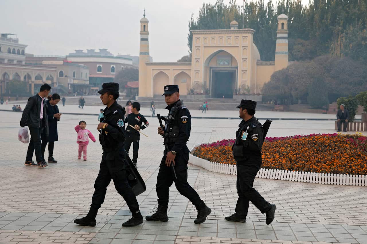Uighur security personnel patrol near the Id Kah Mosque in Kashgar in western China's Xinjiang region.