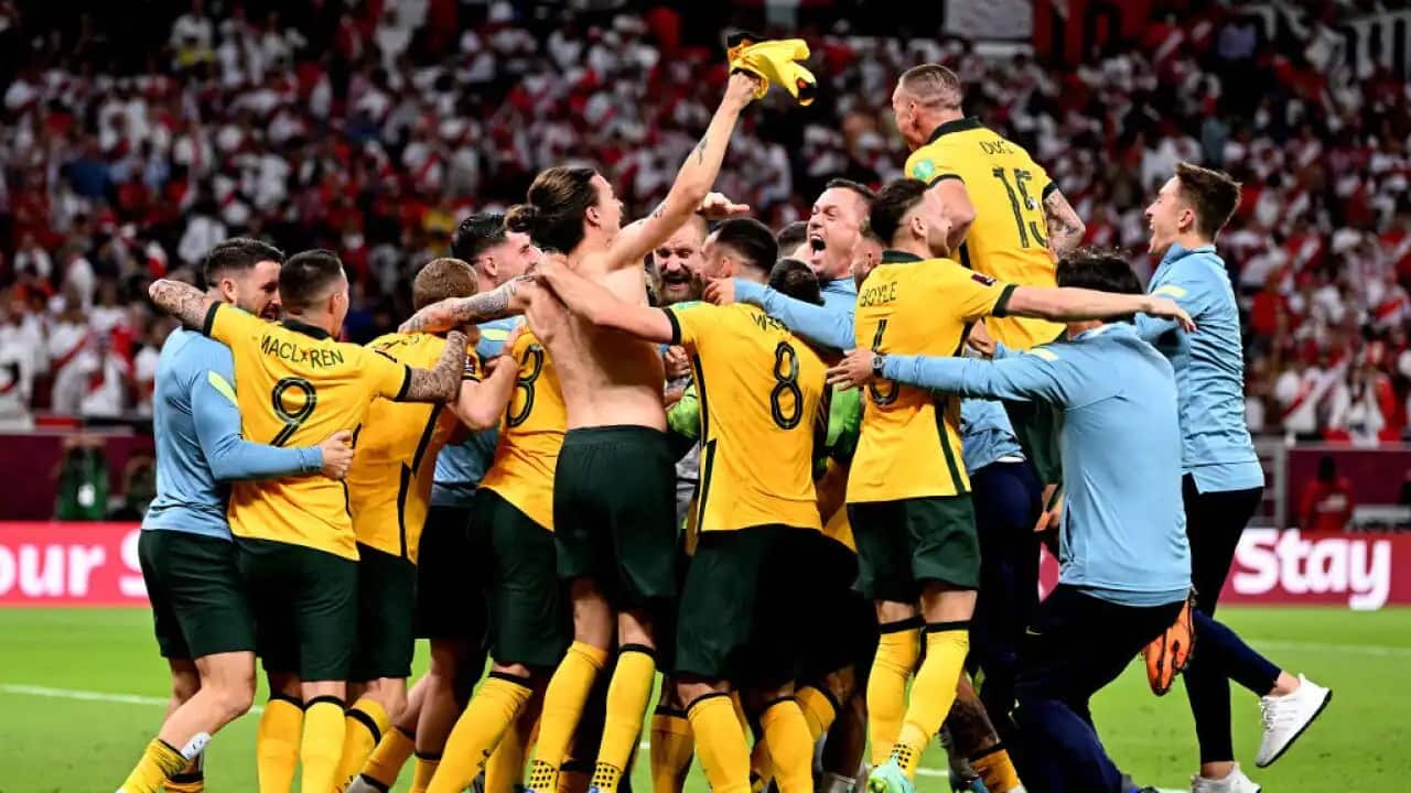 The Socceroos celebrate after qualifying for the 2022 FIFA World Cup with a 5-4 win on penalties over Peru in Doha.