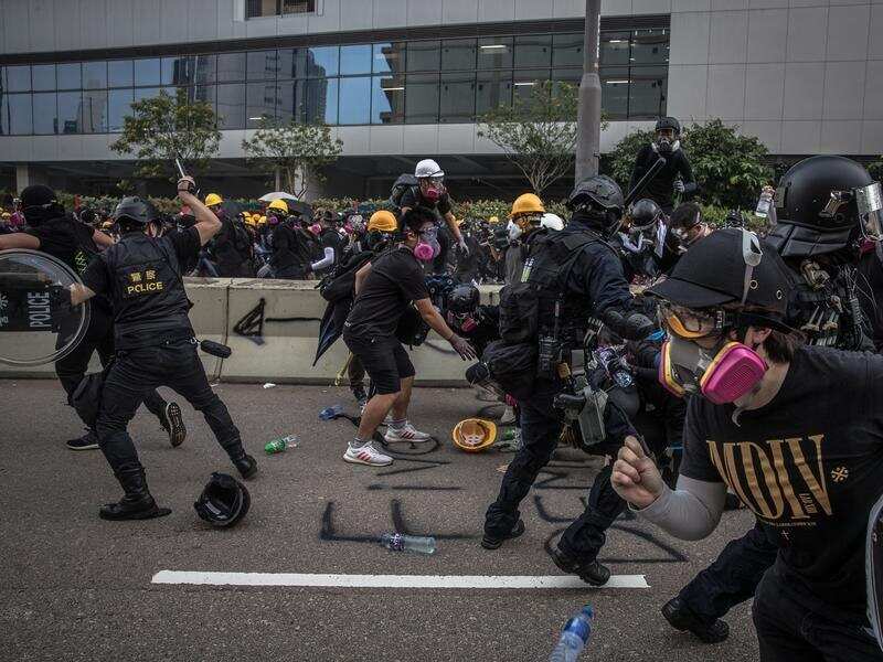 Protesters and police clash on a street in Kwun Tong