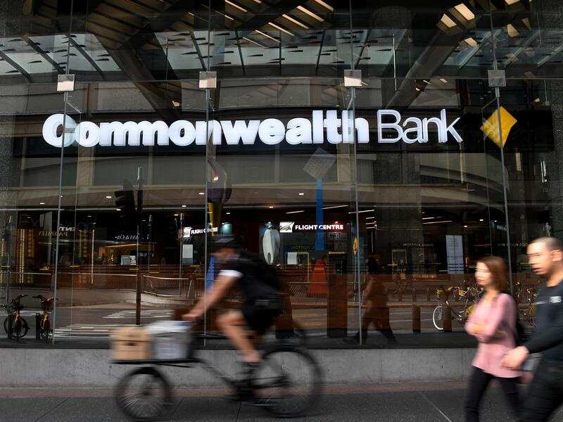 People walk by a Commonwealth Bank