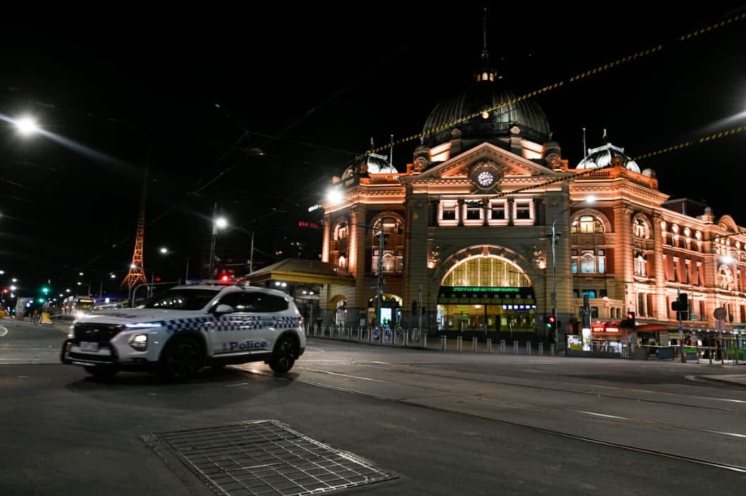 A police car is seen outside Flinders Street Station after a citywide curfew is introduced in Melbourne, Sunday, 2 August, 2020. 