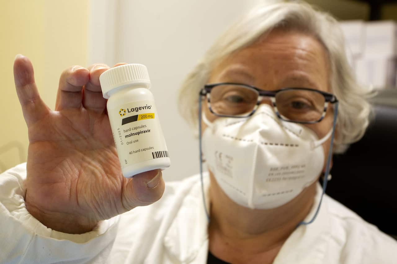 : Doctor shows the bottle of Lagevrio pills, Molnupiravir