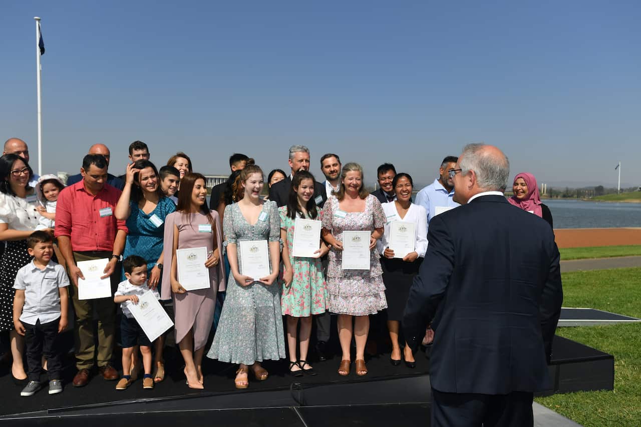 Prime Minister Scott Morrison talks with new citizens during an Australia Day Citizenship Ceremony