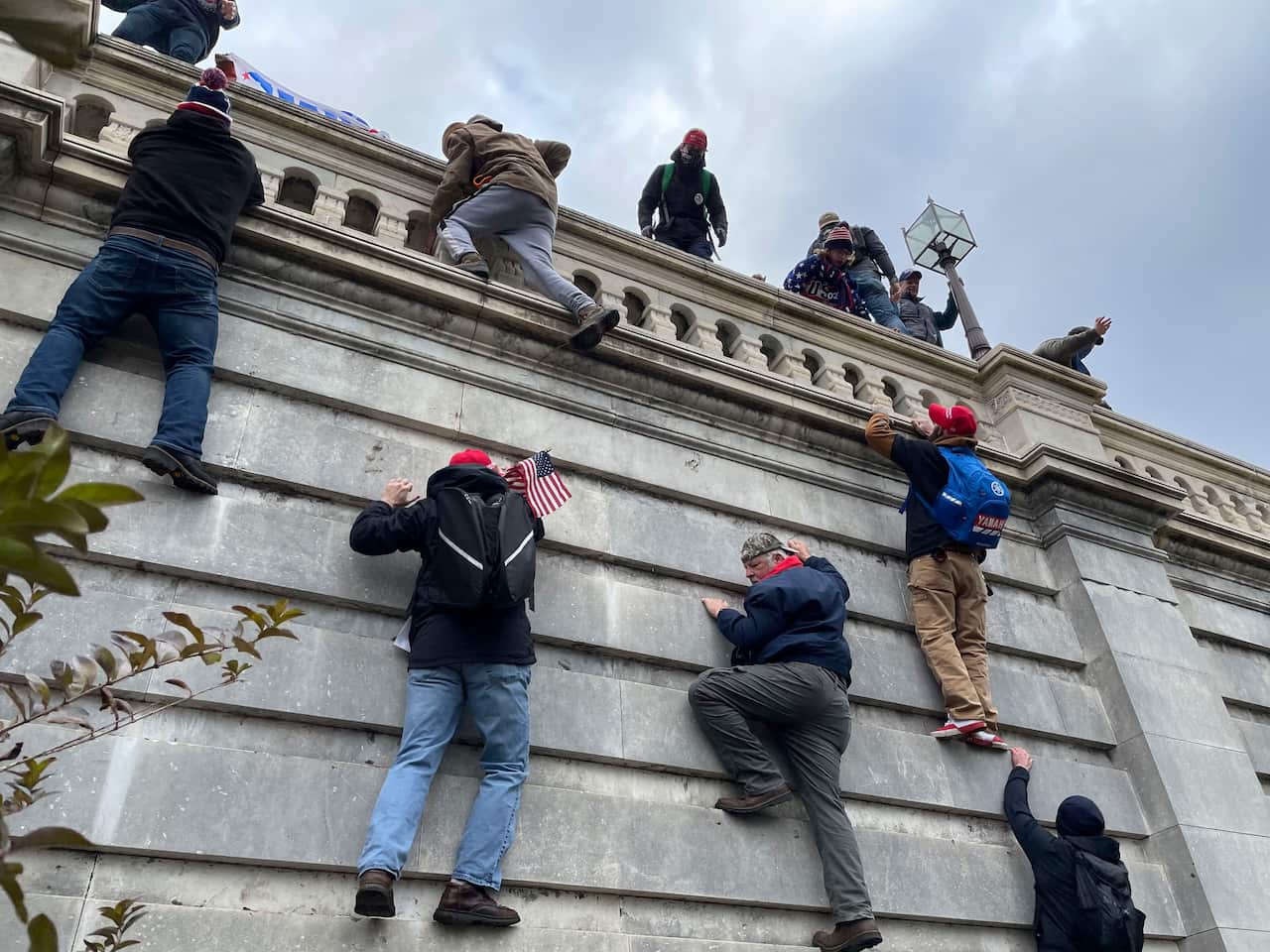 Protesters scale the walls of United States Capitol Building in Washington, D.C.
