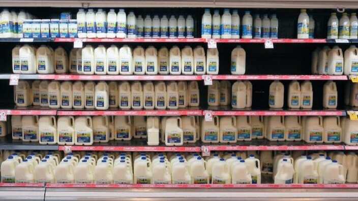 Fridges stocked with milk in a Coles supermarket in Sydney. 